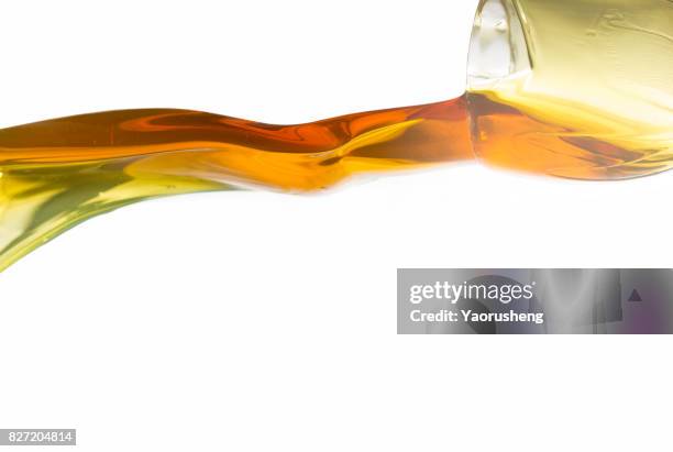active oil splash in white background - oil flow stockfoto's en -beelden