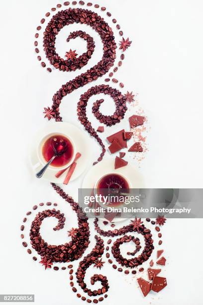 coffee grains lying in the shape of a swirl with the cup, cinnamon, anise stars, chocolate - chocolate swirl from above stock pictures, royalty-free photos & images