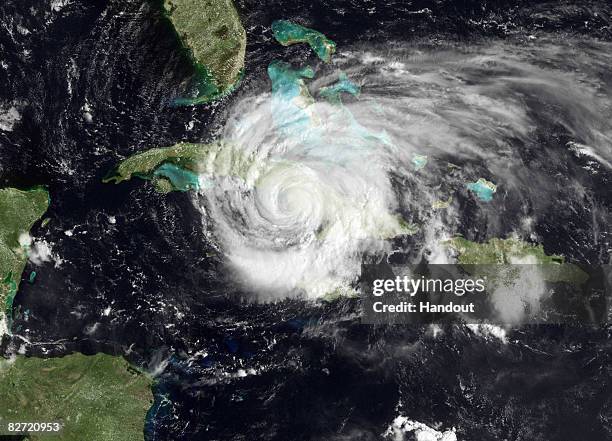 In this satellite image provided by the National Oceanic and Atmospheric Administration , Hurricane Ike is seen moving across the eastern part of...