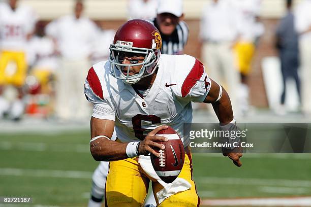 Quarterback Mark Sanchez of the Southern California Trojans moves to pass during the game against the Virginia Cavaliers at Scott Stadium on August...