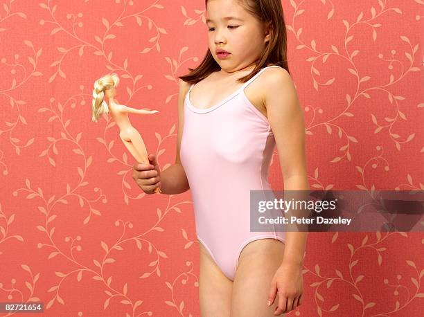 young girl mimicking dolls figure - skinny girl stock pictures, royalty-free photos & images