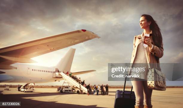 young woman with suitcase arrived at the airport - wingwalking stock pictures, royalty-free photos & images