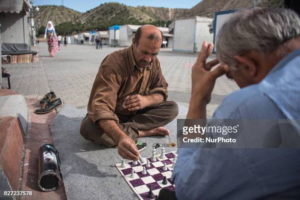 Syrian refugees play chess in the refugee camp Nizip 2, Turkey, 7 August 2017.