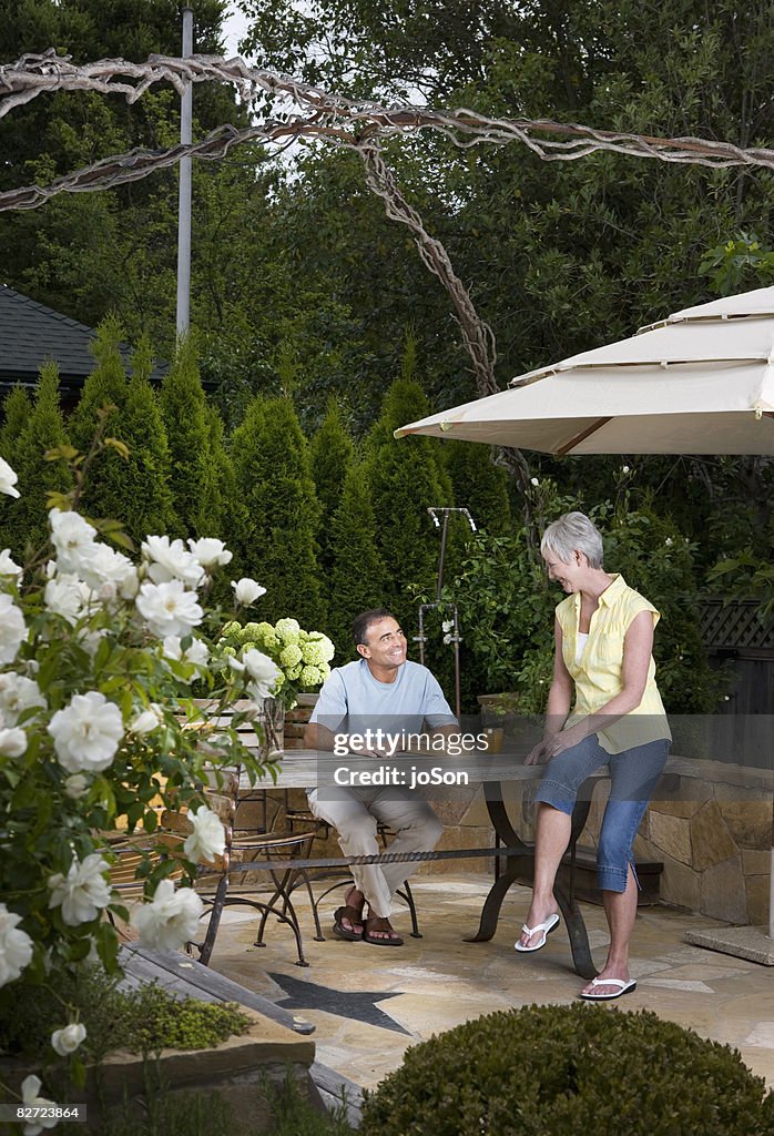 Mature couple relaxing in yard
