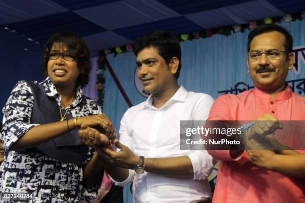 Indian Women Cricket Team member and Star blower Jhulan Ghoswami tying a Rakhi on the wrist of Laxmiratan Shukla and state sports minister Aroop...