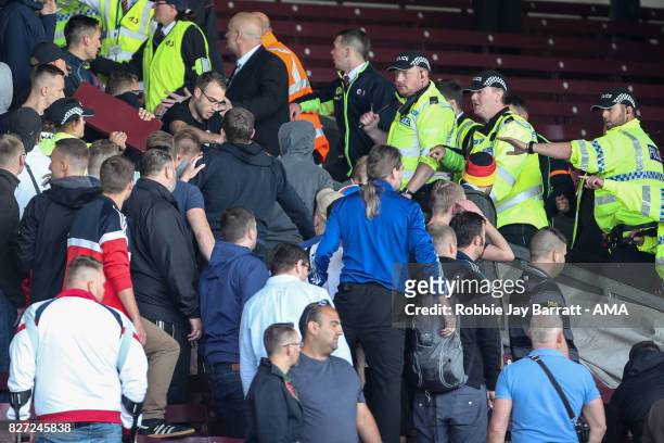 Fans of Hannover 96 confront the police during the Pre-Season Friendly between Burnley and Hannover 96 at Turf Moor on August 5, 2017 in Burnley,...
