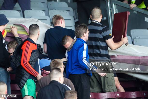 Fans of Hannover 96 rip up chair seats during the Pre-Season Friendly between Burnley and Hannover 96 at Turf Moor on August 5, 2017 in Burnley,...