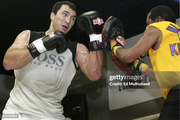 Heavyweight Wladimir Klitschko punches the mitts with trainer Emanuel Steward for his upcoming fight against Samuel Peter. Klitschko and Peter will...