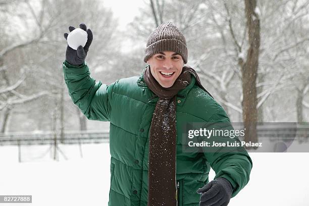 young man about to throw snowball - roupa quente imagens e fotografias de stock