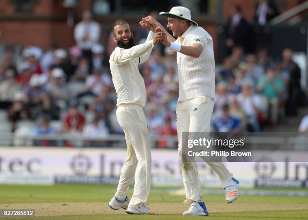 Moeen Ali of England celebrates with Stuart Broad after dismissing Theunis de Bruyn of South Africa during the fourth day of the 4th Investec Test...