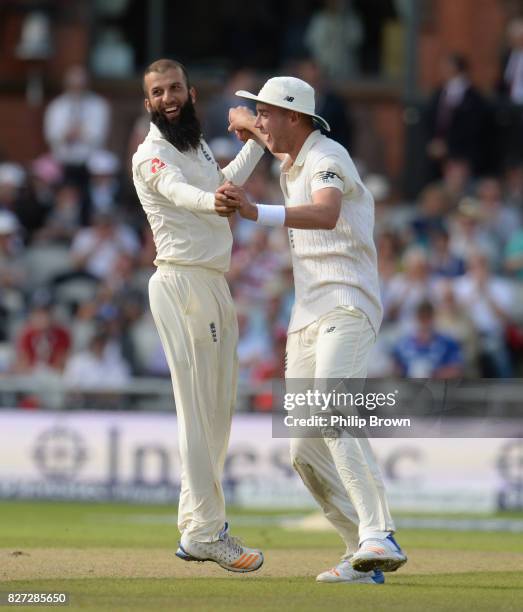 Moeen Ali of England celebrates with Stuart Broad after dismissing Theunis de Bruyn of South Africa during the fourth day of the 4th Investec Test...