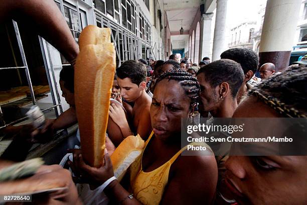 Cubans line up to buy bread in a bakery in the Centro Habana district as the island awaits the impact of Hurricane Ike September 8, 2008 in Havana,...