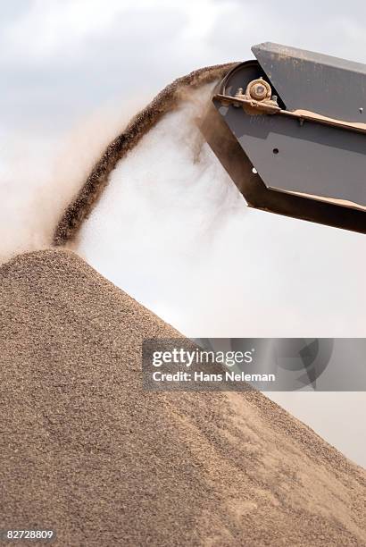 bulldozer adding dirt to the road - sand pile stock pictures, royalty-free photos & images