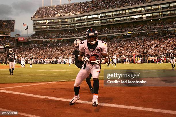 Eddie Royal of the Denver Broncos catches a touchdown past over Gibril Wilson of the Oakland Raiders during an NFL game at McAfee Coliseum on...