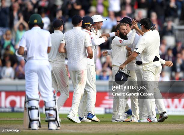 Moeen Ali of England celebrates with teammates after taking the final wicket of Duanne Olivier of South Africa to win the 4th Investec Test match...