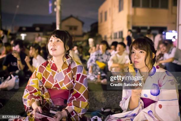 young women looking at fireworks show - funabashi stock pictures, royalty-free photos & images