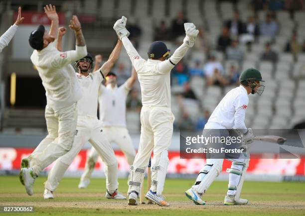 South Africa batsman Duanne Olivier is caught by Ben Stokes at slip as Jonny Bairstow looks on off the bowling of Moeen Ali during day four of the...