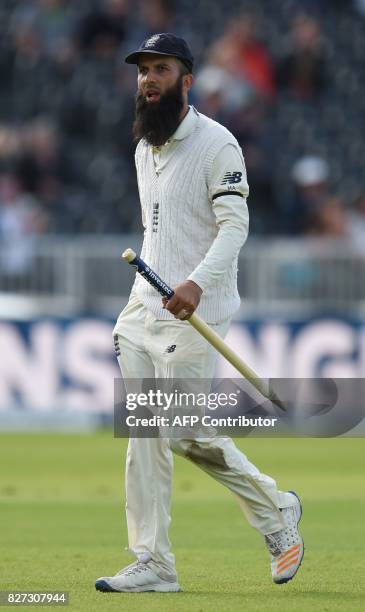 England's Moeen Ali carries a stump as he leaves the field after England won the fourth Test match against South Africa on day 4 of the fourth Test...