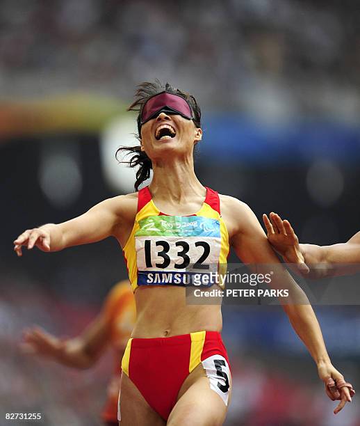 Partially sighted runner Wu Chunmiao of China reacts after winning gold with her guide in the final of the 100m T11 final A during the 2008 Beijing...