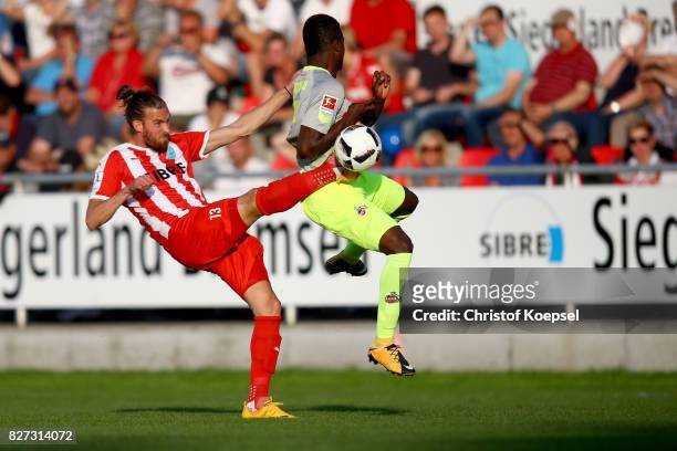 Daniel Reith of Steinbsch challenges Jhon Cordoba of Koeln during the preseason friendly match between TSV Steinbach and 1. FC Koeln at...