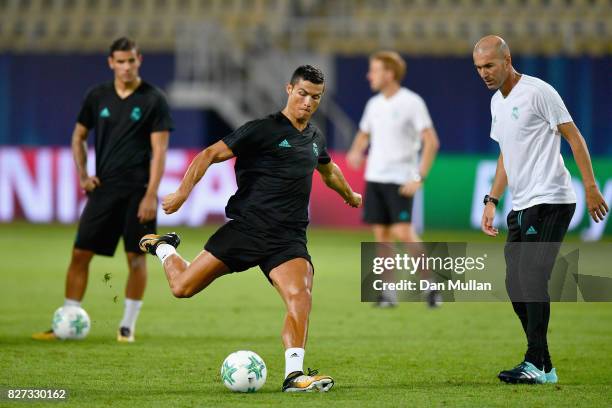 Cristiano Ronaldo of Real Madrid shoots as Zinedine Zidane, Manager of Real Madrid watches during a training session ahead of the UEFA Super Cup...