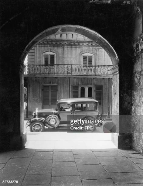 Car glimpsed through an arch of the old Cabildo in New Orleans, circa 1935.