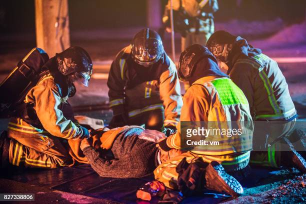 firefighters providing first aid - fire rescue stock pictures, royalty-free photos & images