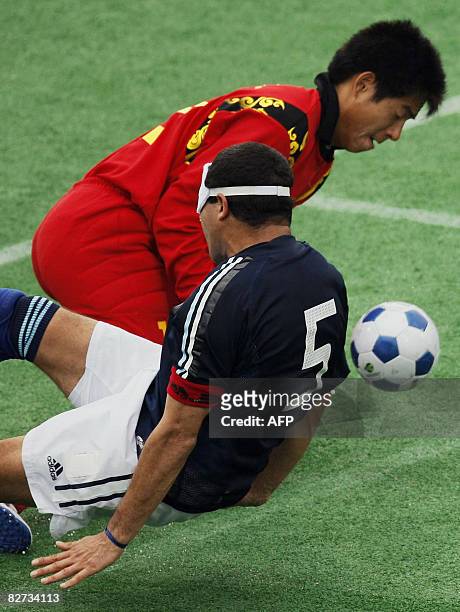 China's Xia Zheng clashes with Argentina's Velo Silvio in the men's 5-a-side football match during the 2008 Beijing Paralympic Games at the Olympic...