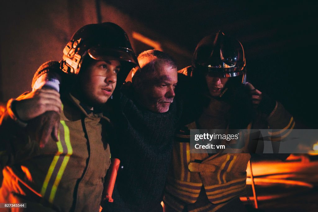 Firefighters helping a man