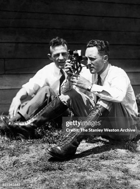 June 29: Commander Richard E. Byrd of the United States Navy looks through his sextant while his assisteant looks on as they wait for weather to...