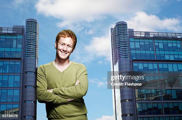 portrait of man leaning against office building - large stockfoto's en -beelden