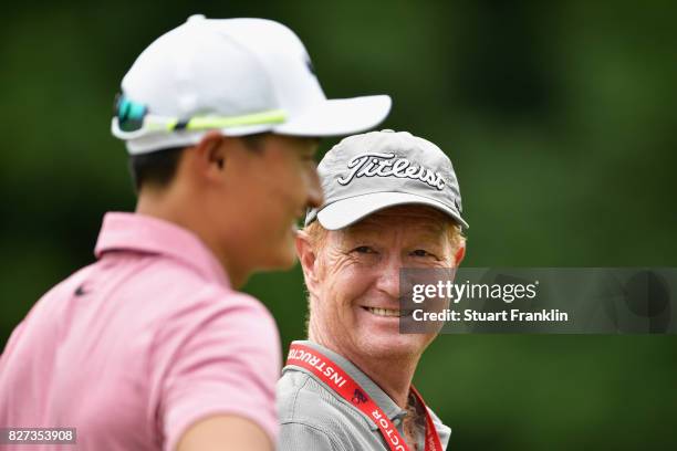 Coach Jamie Gough speaks to Haotong Li of China during a practice round prior to the 2017 PGA Championship at Quail Hollow Club on August 7, 2017 in...