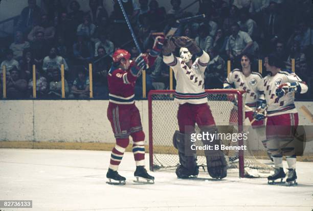 Canadian ice hockey player John Davidson , goalkeeper for the New York Rangers, scuffles with an unidentified player from CSKA Moscow, both with...