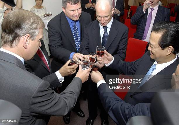 Britain's Prince Andrew and Vietnamese Prime Minister Nguyen Tan Dung raise a toast with two unidentified delegates in Ho Chi Minh City on September...