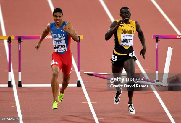 Kemar Mowatt of the Jamaica hits a hurdle along side Juander Santos of Dominica Republic as they compete in the Men's 400 metres hurdles semi finals...