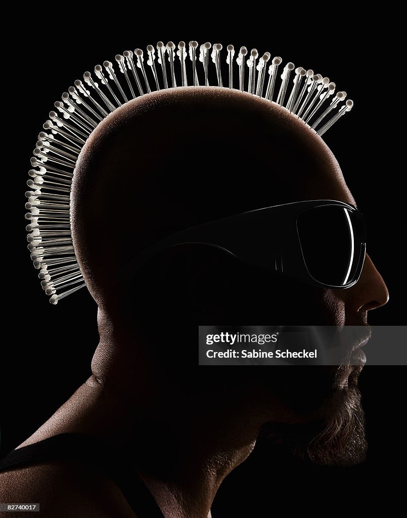 Silhouette of man's face with pins