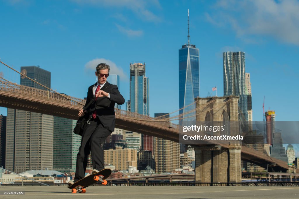 Businessman skateboarding in New York City