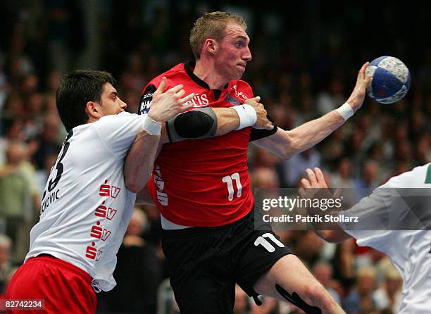 Holger Glandorf of Nordhorn battles for the ball with Nenad Vuckovic of Melsungen during the Toyota Handball Bundesliga match between HSG Nordhorn...