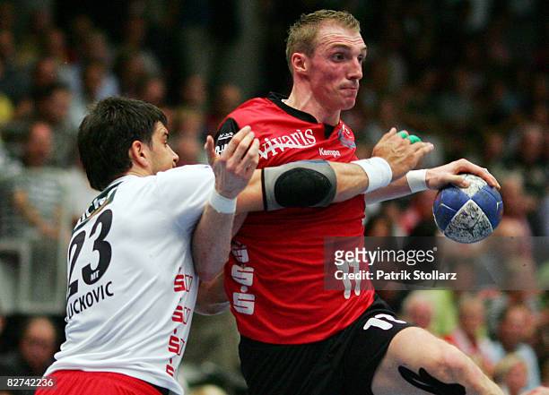 Holger Glandorf of Nordhorn battles for the ball with Nenad Vuckovic of Melsungen during the Toyota Handball Bundesliga match between HSG Nordhorn...