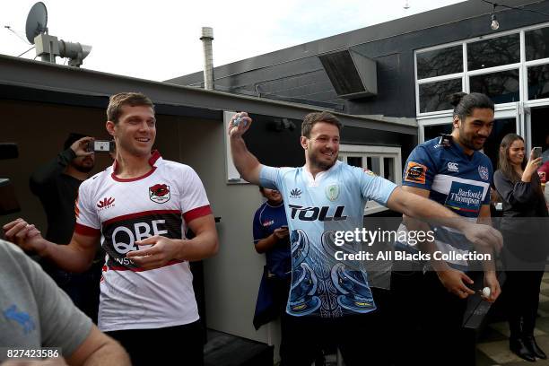 Matt Duffie, Matt Moulds and Michael Fatialofa throw paint bombs at a map of New Zealand during the Mitre 10 Cup Season Launch at the College Rifles...