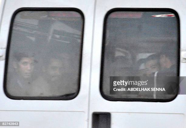 Part of the 15 suspected members of an Islamist network leave in a police van in Rabat on September 9, 2008. Fifteen suspected members of an Islamist...