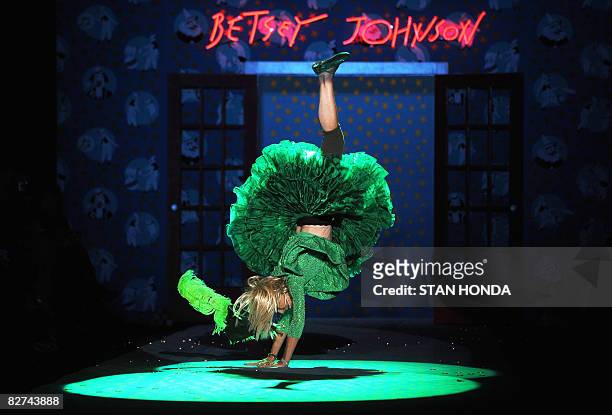 Designer Betsey Johnson does a cartwheel after her spring 2009 collection show at Mercedes-Benz Fashion Week on September 9, 2008 in New York. AFP...