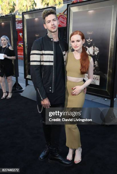 Recording artist Travis Mills and actress Madelaine Petsch attend the premiere of New Line Cinema's "Annabelle: Creation" at TCL Chinese Theatre on...
