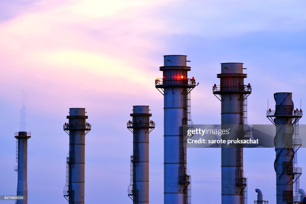 Oil-refinery plant at sunset sky .