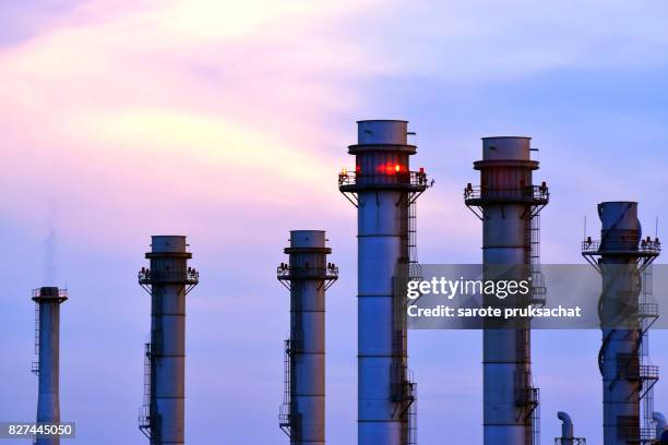 oil-refinery plant at sunset sky . - coal power plant stockfoto's en -beelden