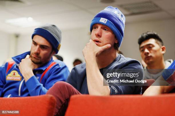 Bulldogs players Easton Wood and Liam Picken listen as Matthew Boyd speaks to media after announcing his retirement sduring a Western Bulldogs AFL...