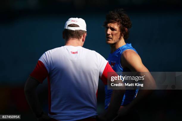 Kurt Tippett of the Swans talks to Swans head coach John Longmire during a Sydney Swans AFL training session at Sydney Cricket Ground on August 8,...