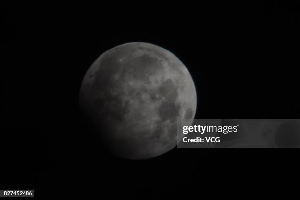 The moon is seen during partial lunar eclipse on August 8, 2017 in Chengdu, Hebei Province of China.