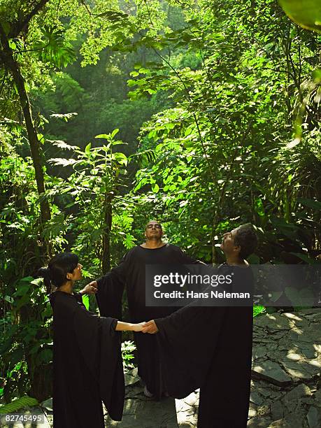 three people praising the earth - paganism stock pictures, royalty-free photos & images