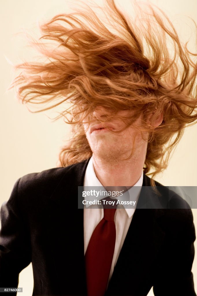 Young man with long hair covering face